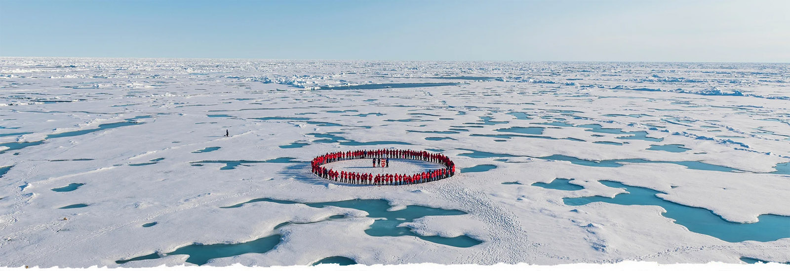 Group of people standing in a circle at the North Pole